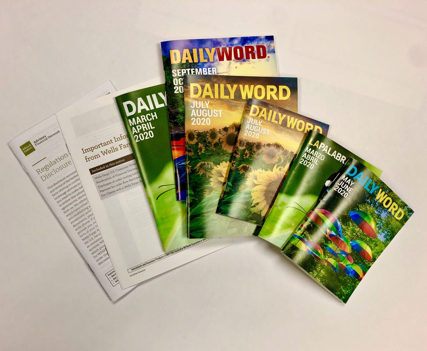 A fan of printed devotional booklets in bright seasonal covers